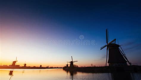 traditional dutch windmills from the canal in rotterdam