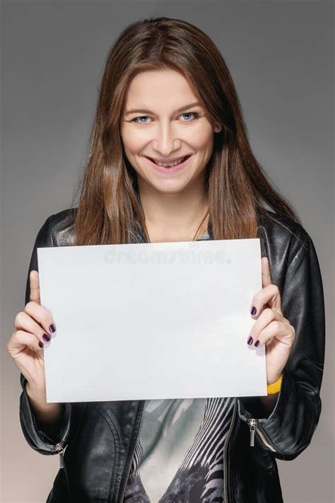 pretty smiling girl holding blank sheet  paper   hands stock