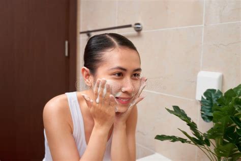 Young Beautiful Asian Woman Washing Her Face With Hands By Soap Stock