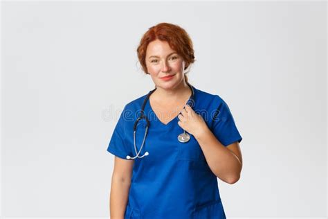 Smiling Caring Middle Aged Redhead Doctor Female Physician In Blue