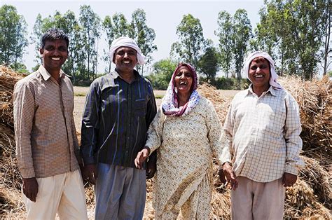 happy rural farmer family standing   field  smiling