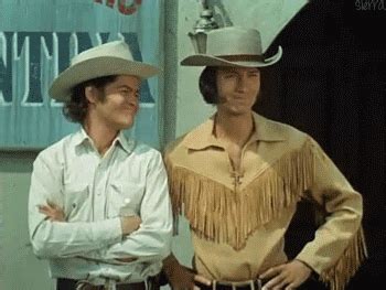 men  cowboy hats standing       hands   hips