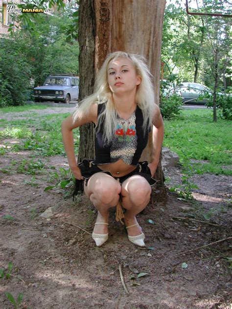 pee needed blonde squats behind a tree to relieve herself