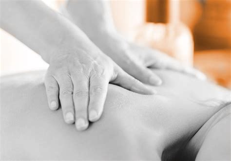 attractive woman having a massage with massage oil in a spa mphc