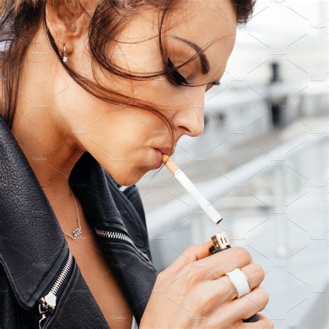 portrait  young woman smoking cigarette background stock