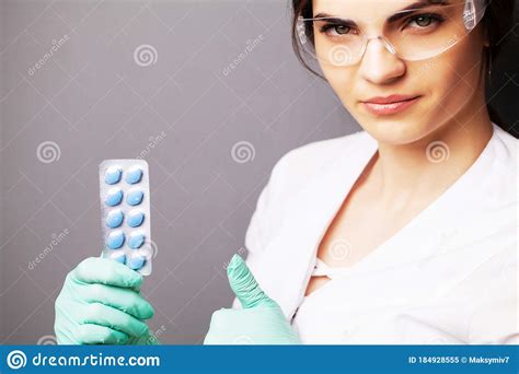 sexual health a doctor in a white coat holding a pill for a healthy