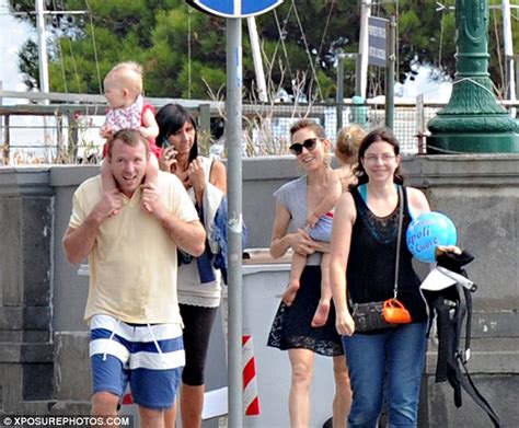guy ritchie frolics on italian beach with girlfriend and daughters while taking a break from