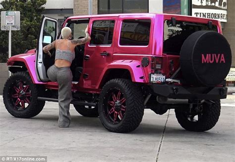 amber rose stops traffic in booty hugging trousers while hoppng into