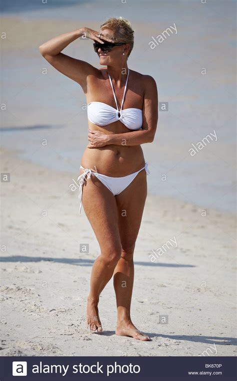 Healthy And Fit Looking Mature Woman In A White Bikini