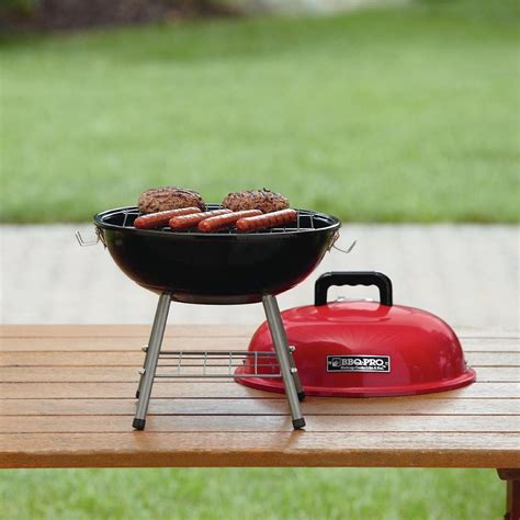 grill  hot dogs   sitting   picnic table    red kettle