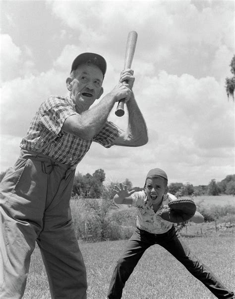 1950s grandfather at bat with grandson photograph by vintage images