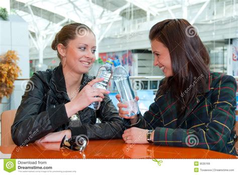 two girls drink water in food court in a mall stock image image of happy lifestyle 9535169