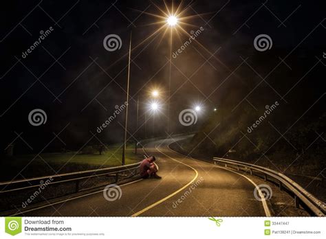 troubled teenager with hidden face sitting in the night