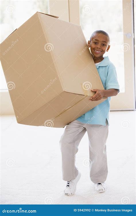 young boy holding box   home smiling stock photo image  people
