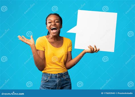 excited girl holding speech bubble shouting standing  blue background