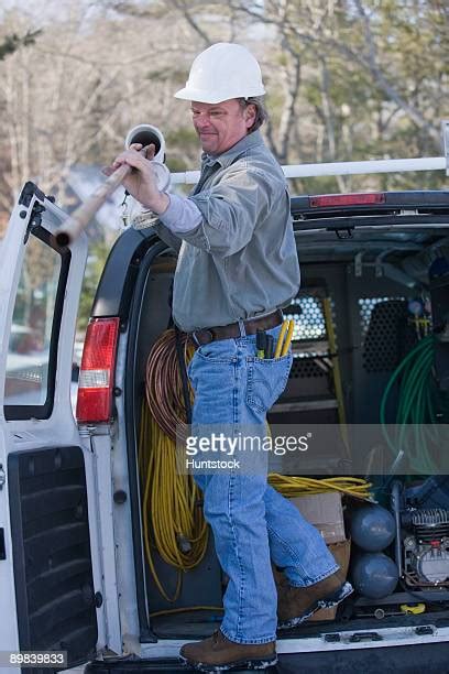 plumber taking out a copper pipe from his truck photos et images de