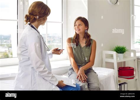 Happy Teenage Girl Is Listening To Doctor During Medical Examination In