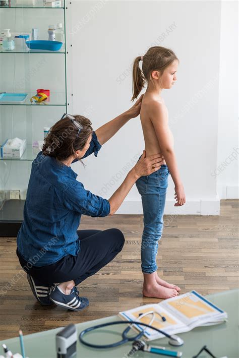 Doctor Examining Back Of 8 Year Old Girl Stock Image C040 1357