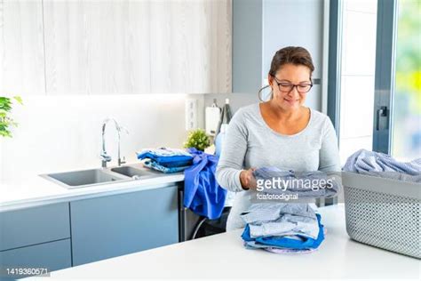 laundromat folding clothes photos and premium high res pictures getty