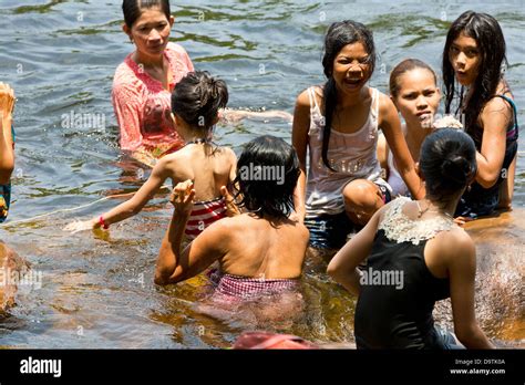 local people taking a bath in the river at the teuk chhou rapids in