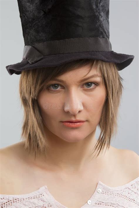 gorgeous female fashion model wearing top hat stock