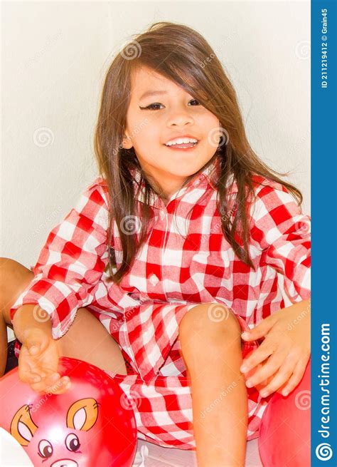 Long Haired Girl In Red Plaid Shirt Make Up Her Lips Look Innocent
