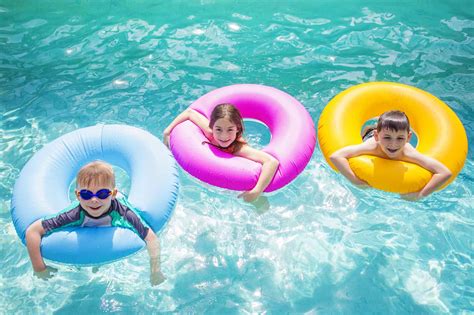 group  kids playing  inflatable tubes  swimming pool
