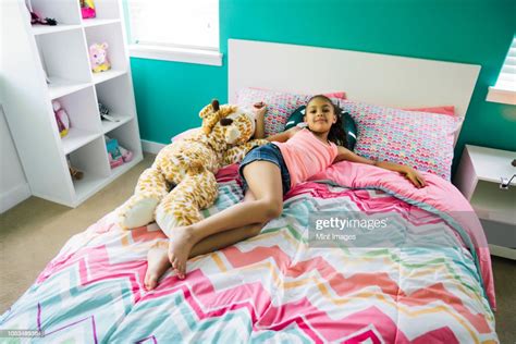 tween girl relaxing on her bed in her bedroom bildbanksbilder getty