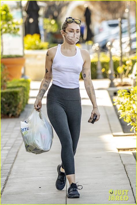 miley cyrus goes braless in see through tank top while running errands