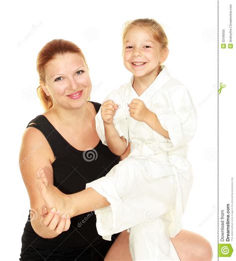 mom teaches daughter dressed in a kimono karate kick