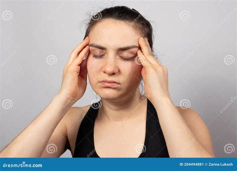 A Tired Woman Holds Her Head With Her Hand Her Head Hurts Brain