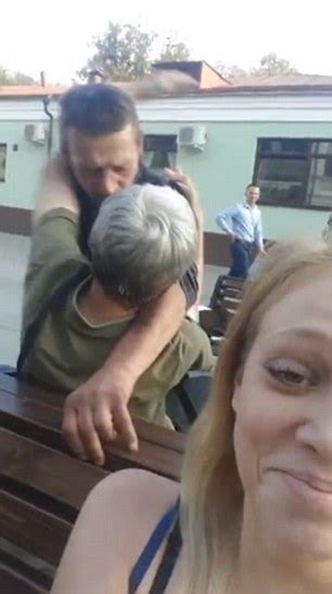 video shows brawl between men in russian street as woman pretends to take selfie daily mail online