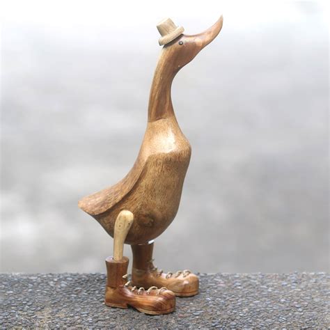 artisan crafted wooden duck sculpture  boots   uncle duck