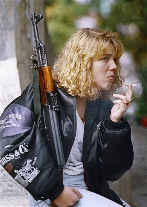 A Bosnian Muslim Girl Holding An Ak 47 Rifle Smokes A