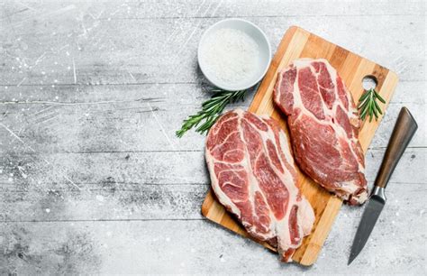 Premium Photo Raw Pork Steaks With Salt