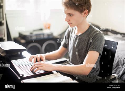 teenage boy typing  laptop stock photo alamy
