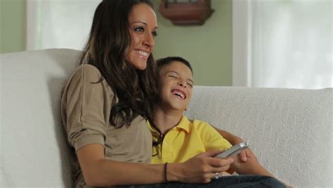 mother and son blowing out the candles on a birthday cake together stock footage video 807505