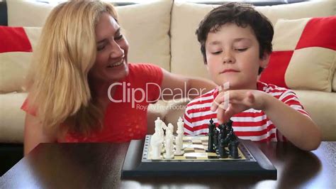 mother teaches son how to play chess royalty free video
