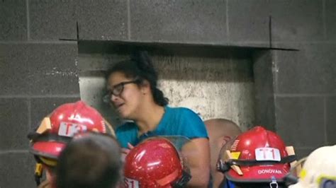 firefighters free us woman trapped between walls