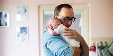 young father holding newborn baby son   arms ypsi arbor childbirth education