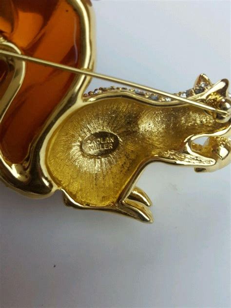 swarovski rhinestone and amber lucite squirrel nolan miller brooch pin