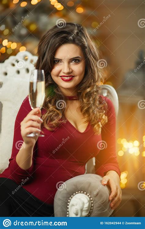 beautiful girl in evening dress sitting on christmas