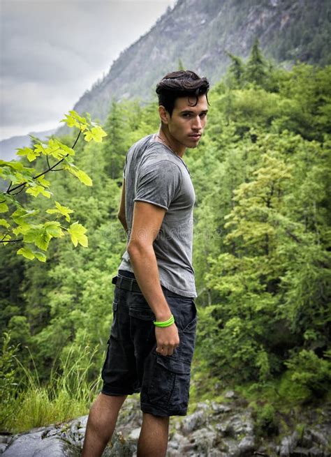 handsome young man hiking  lush green mountain  stock photo image