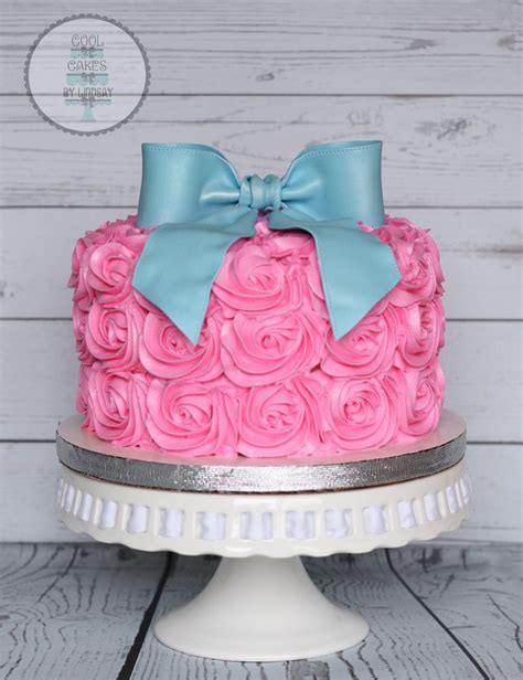 pink and blue gender reveal cake pink rosettes and blue