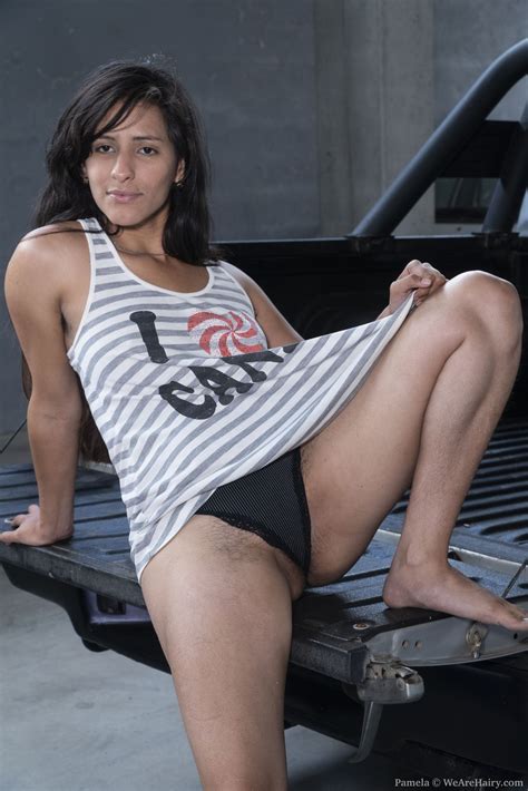 pamela poses naked on her black truck