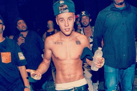 shirtless justin bieber whips out tattooed torso daily star