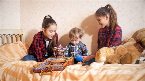 smiling girls playing  bed  toddler boy stock photo affiliate playing bed