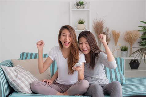 Asia Lesbian Lgbt Couple Holding Remote Watching Tv Show And Cheer
