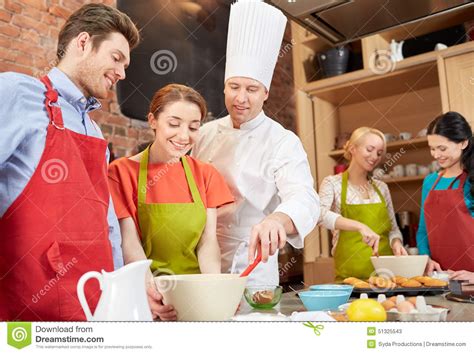 Happy Friends And Chef Cook Baking In Kitchen Stock Image
