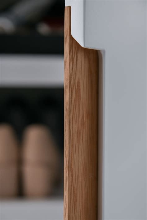close    wooden door handle   white cabinet  shoes
